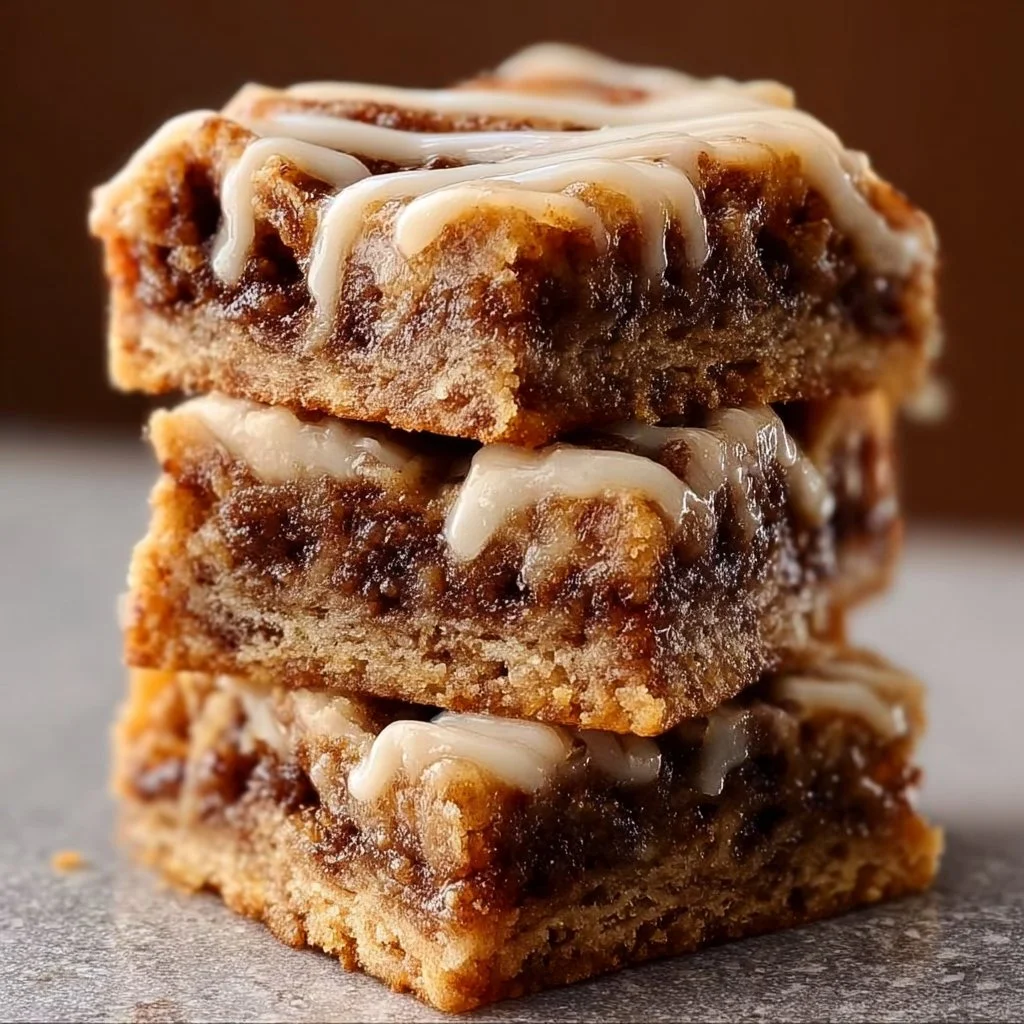 Delicious cinnamon roll bliss bars topped with creamy icing.