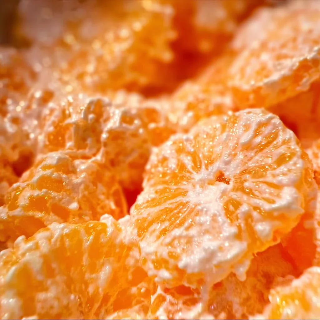Bright and colorful Mandarin Orange Jello Salad served in a bowl