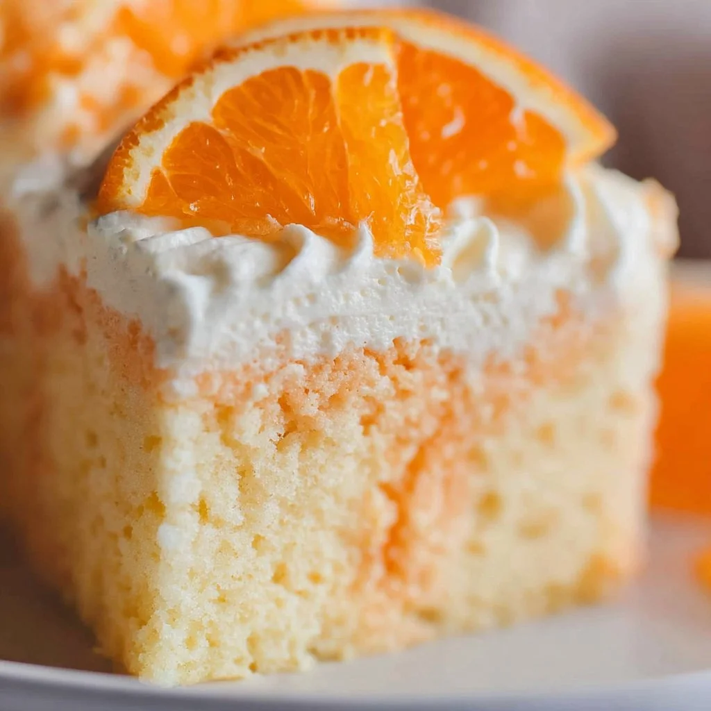 Delicious Orange Creamsicle Cake with vibrant orange frosting and creamy layers.