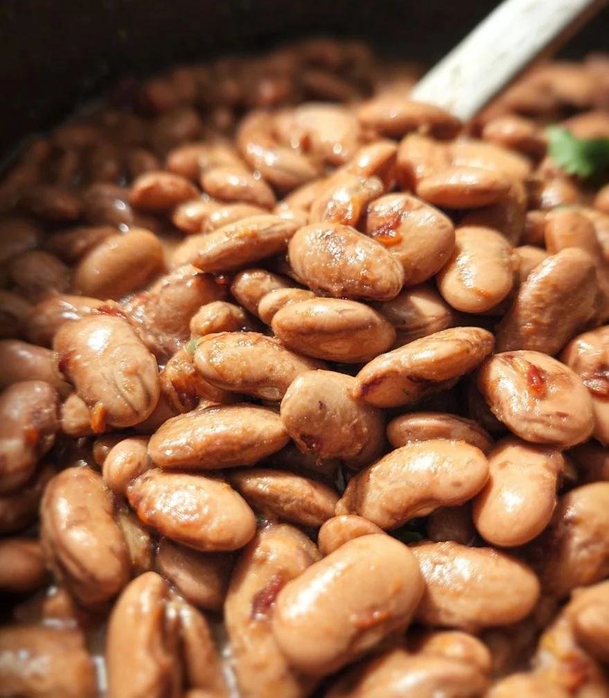 Bowl of flavorful vegan Mexican pinto beans with spices and herbs
